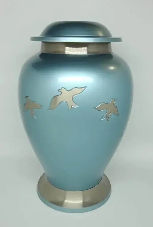 A blue vase with three birds on it is sitting on a table.