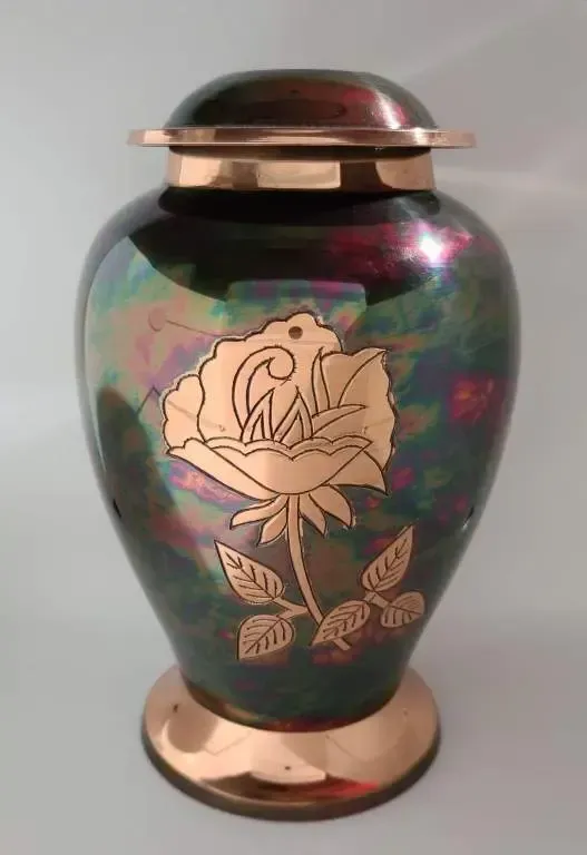 A vase with a rose on it is sitting on a table.