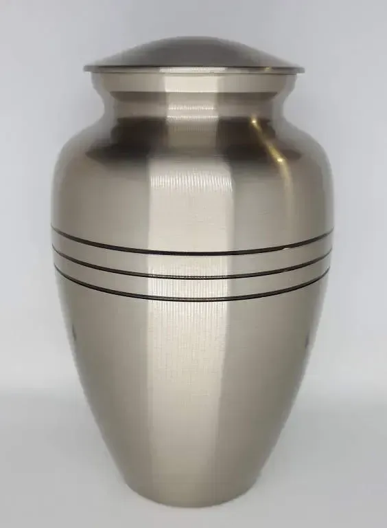 A silver urn with a black stripe on the side