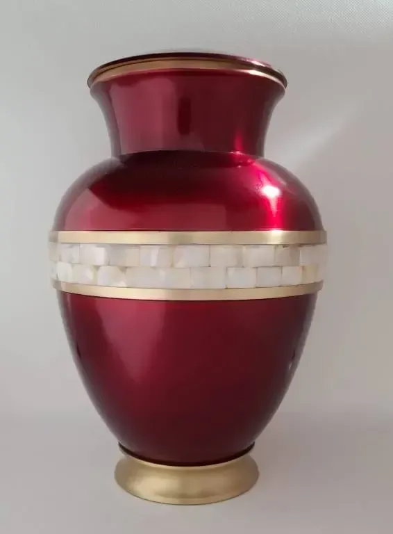 A red vase with a gold stripe on the side