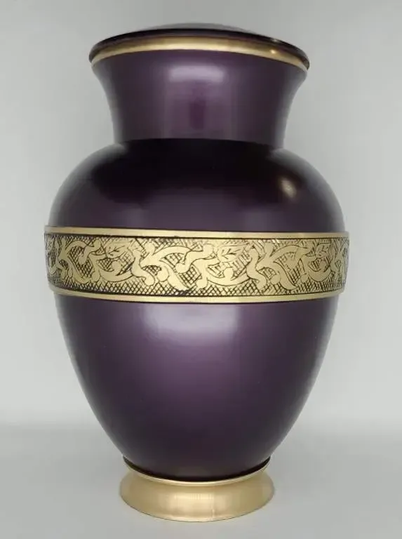 A purple vase with a gold stripe on the side