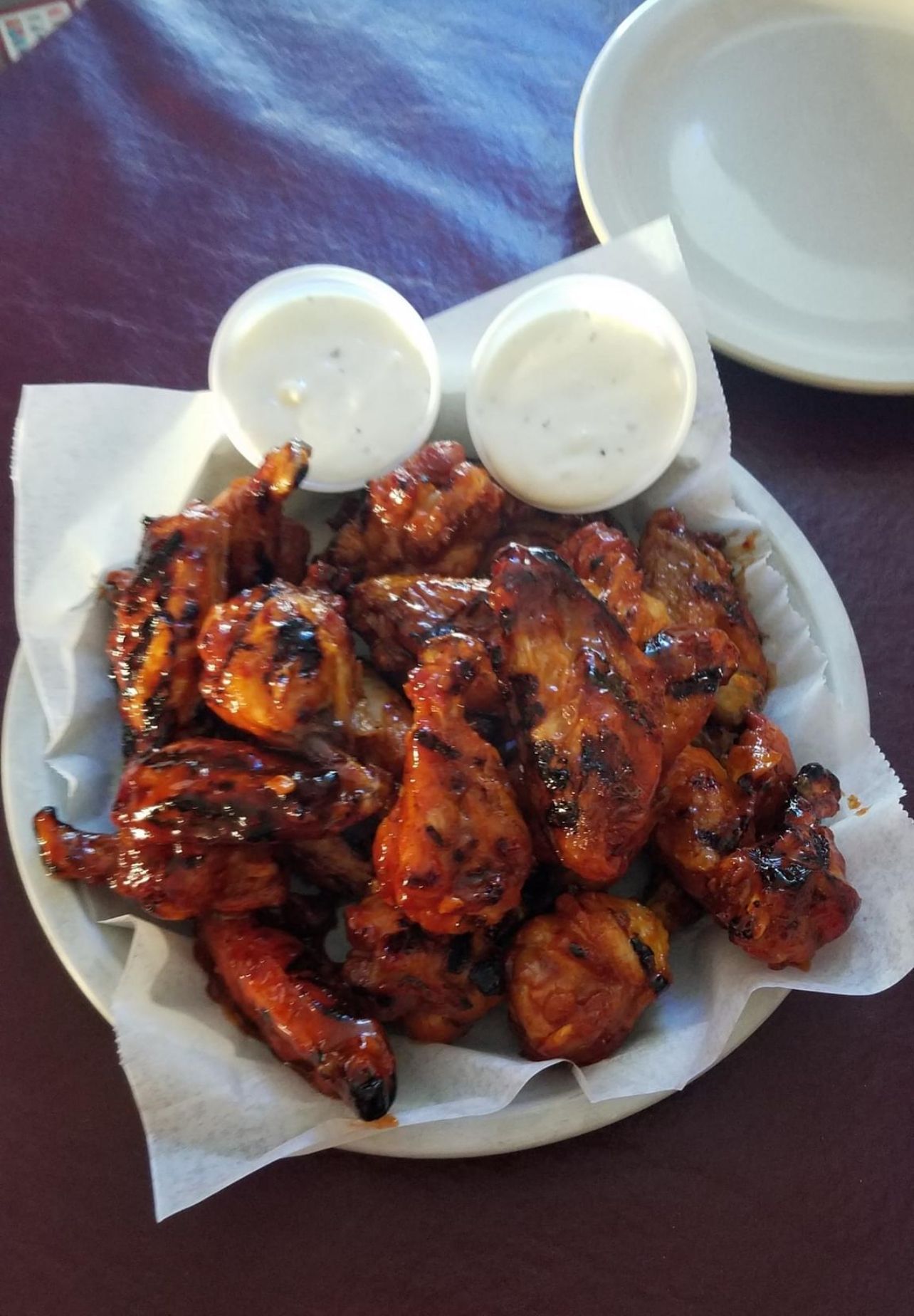 Close up of hand holding wine glass at table.