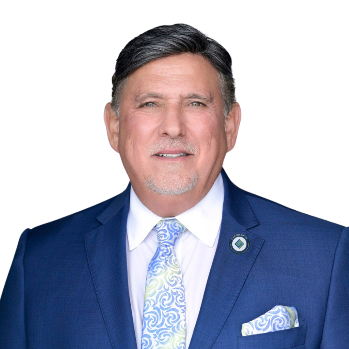 A man in a blue suit and tie is smiling for the camera
