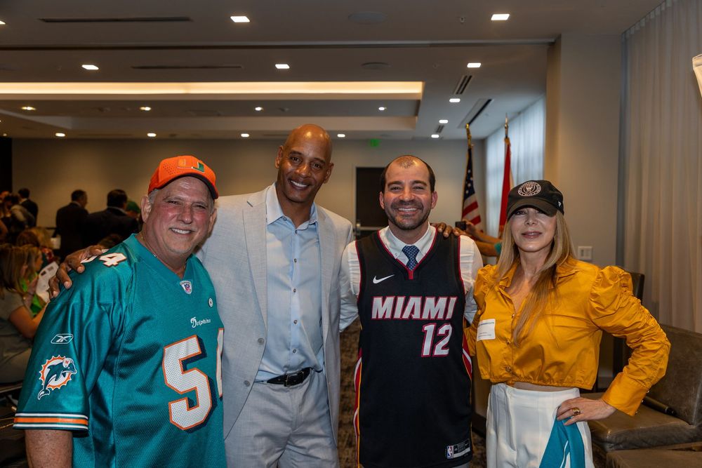 A group of people are posing for a picture in a room.