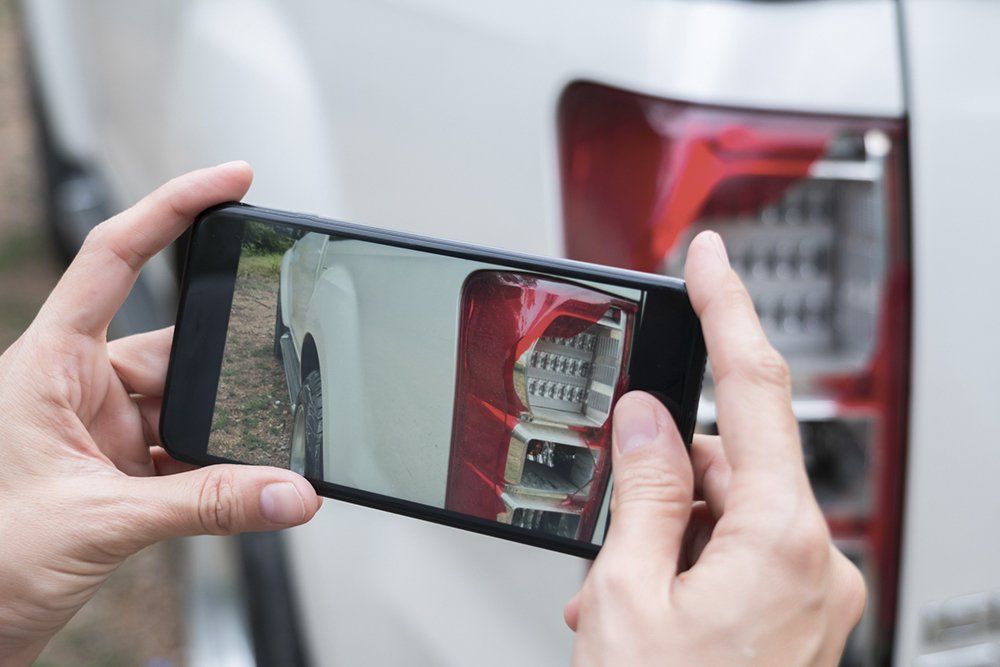 Woman Take Photo Shattered Car Lights | Colorado Springs, CO | Millennium Auto Craft