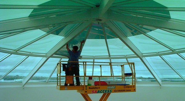 workers applying tint to glass