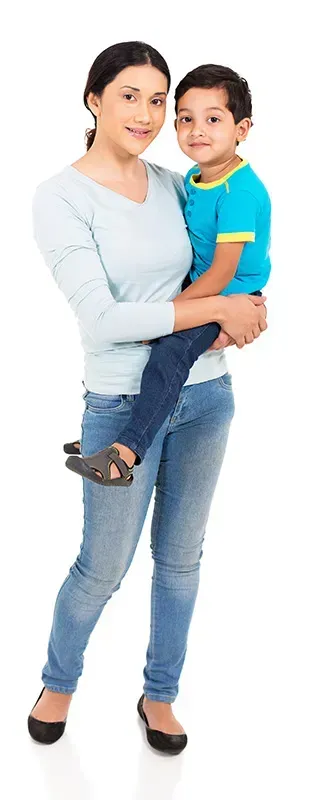 A woman is holding a little boy in her arms.