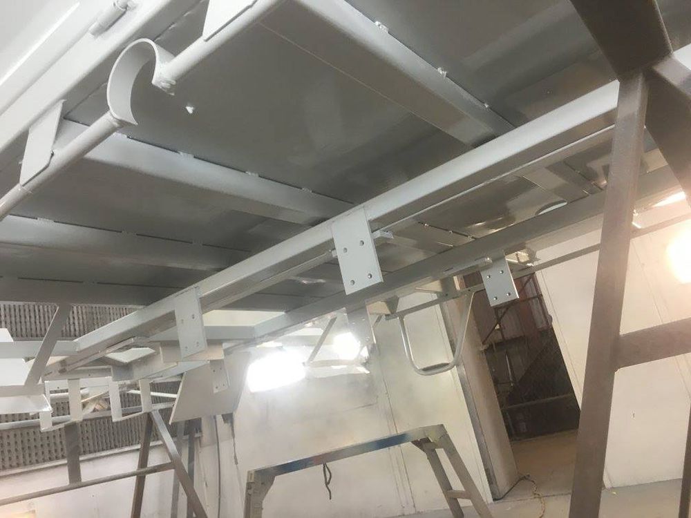 A Metal Structure Is Being Painted in A Powder Coating Shop — ASSB Armidale Sand & Soda Blasting In Guyra, NSW