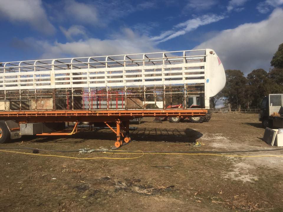 A Large Trailer Is Parked in A Field for Sand Blasting Restoration — ASSB Armidale Sand & Soda Blasting In  Armidale, NSW