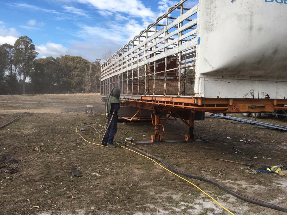 Man Worker Painting The Big Trailer — ASSB Armidale Sand & Soda Blasting In  Armidale, NSW