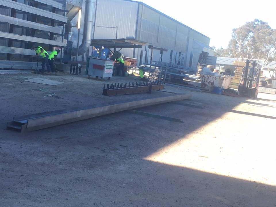 Men Workers In Green Uniforms With Working In Big Metal For Painting — ASSB Armidale Sand & Soda Blasting In Guyra, NSW