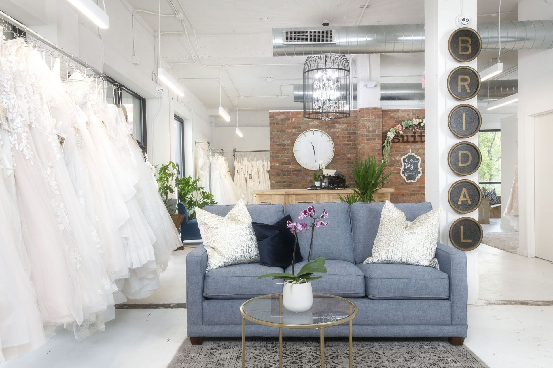A living room with a couch and a table in a bridal store.