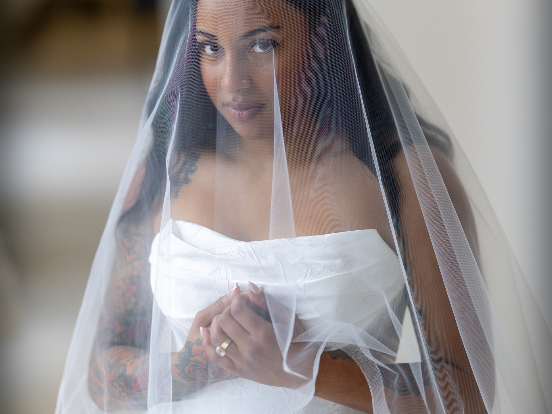 A wedding dress is hanging on a mannequin in a dressing room.