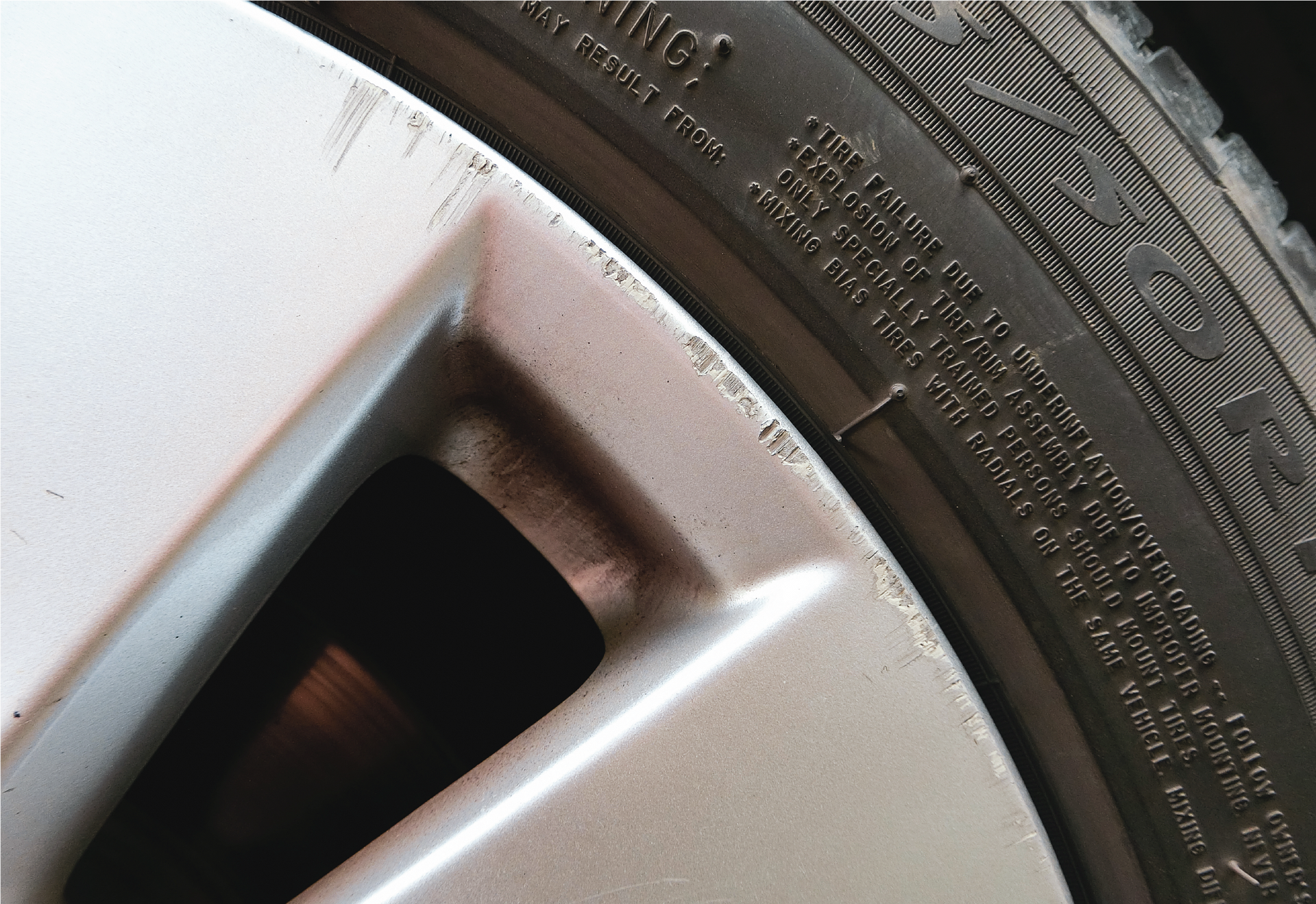 A close up of a car with a scratch on the front bumper