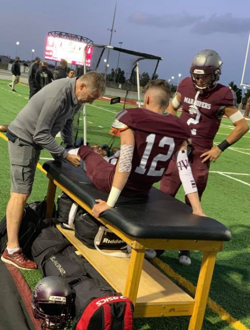 Dr. Justin Sherfey tending to sports injury