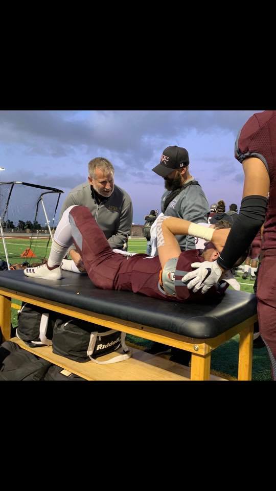 Dr. Justin Sherfey tending to sports injury