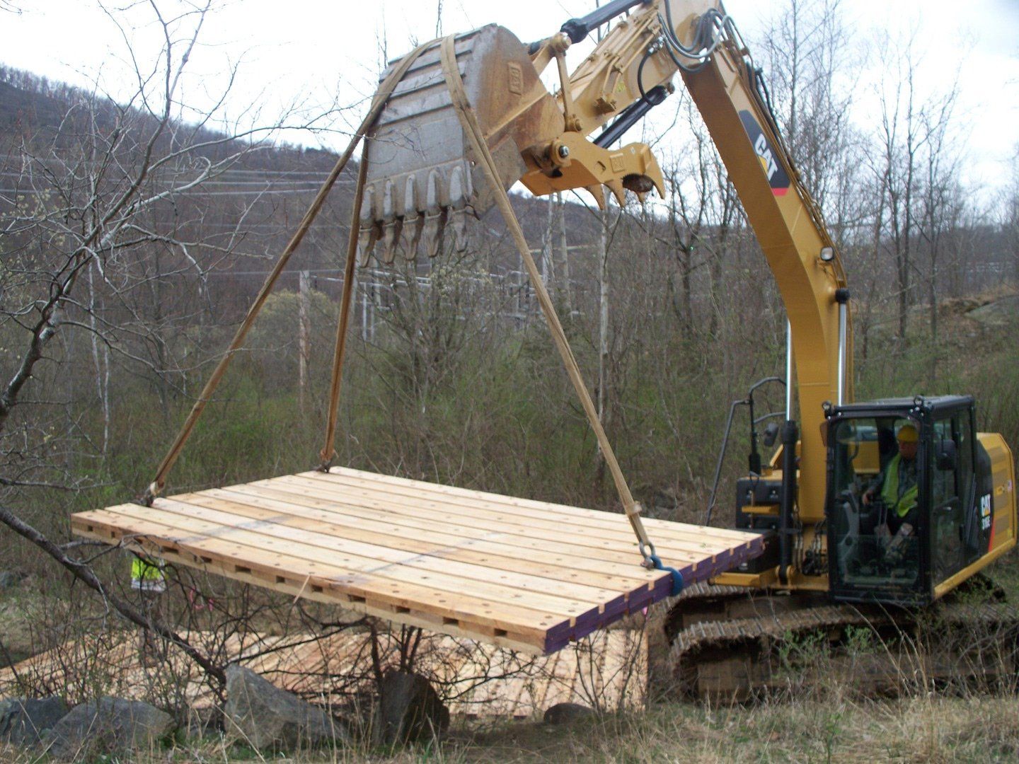 Excavator with Wood — Poughkeepsie, NY — OCS Industries, Inc.