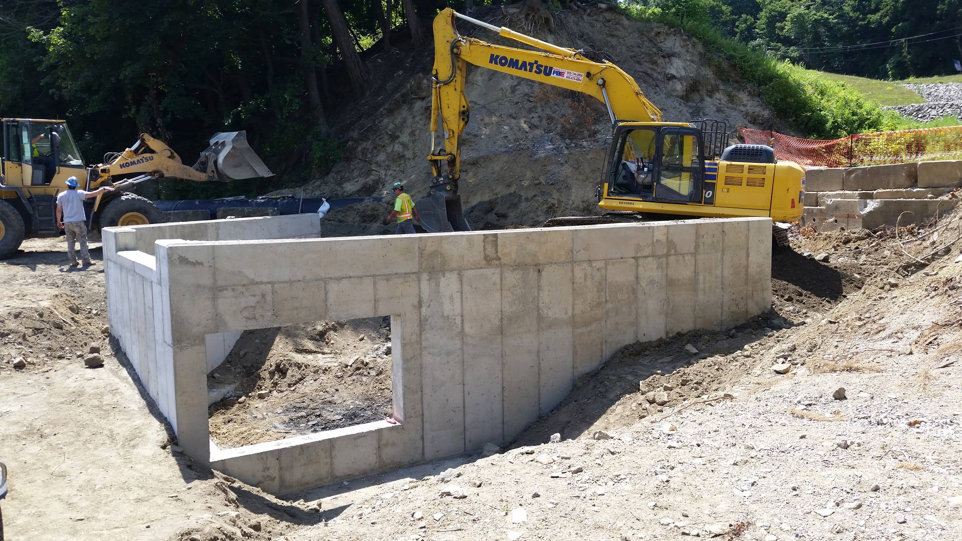 Excavator with Concrete Wall — Poughkeepsie, NY — OCS Industries, Inc.