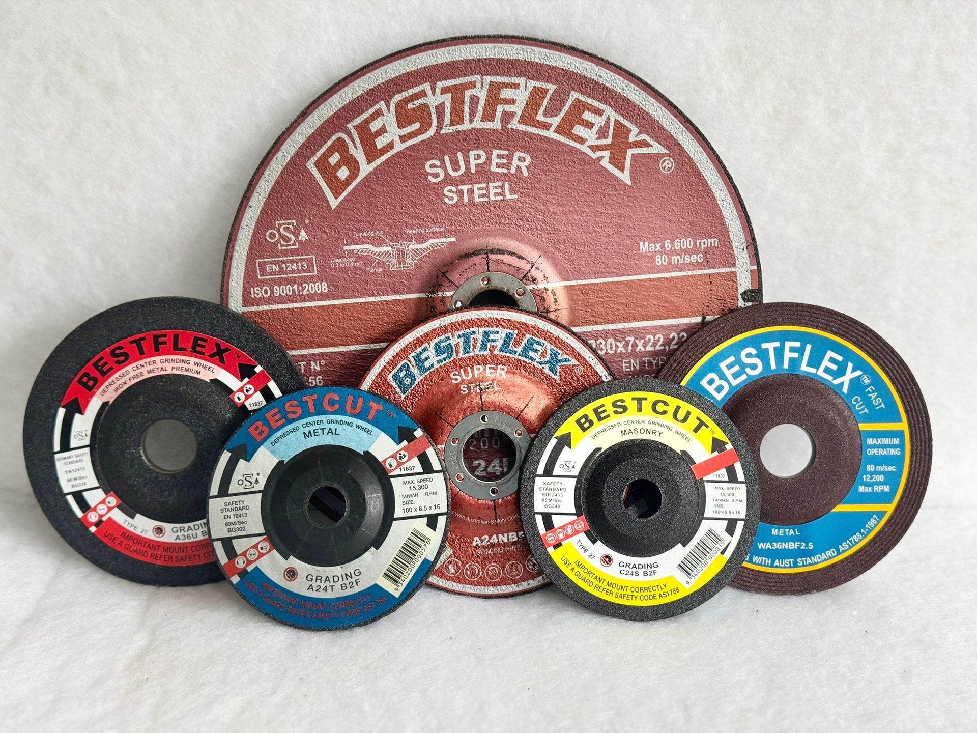 A bunch of cds are sitting on top of each other on a blue surface.