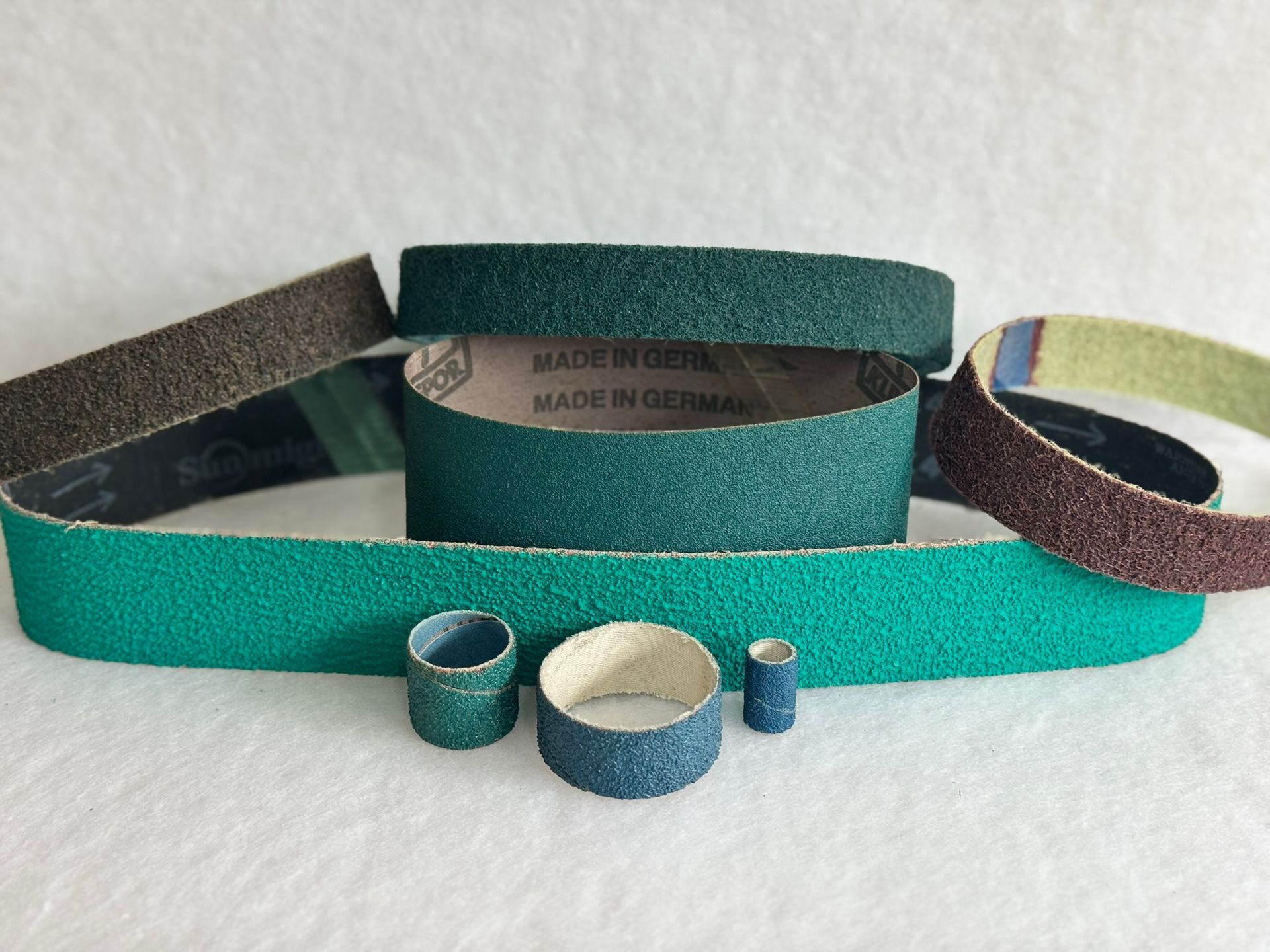 A bunch of belts and tape on a white surface