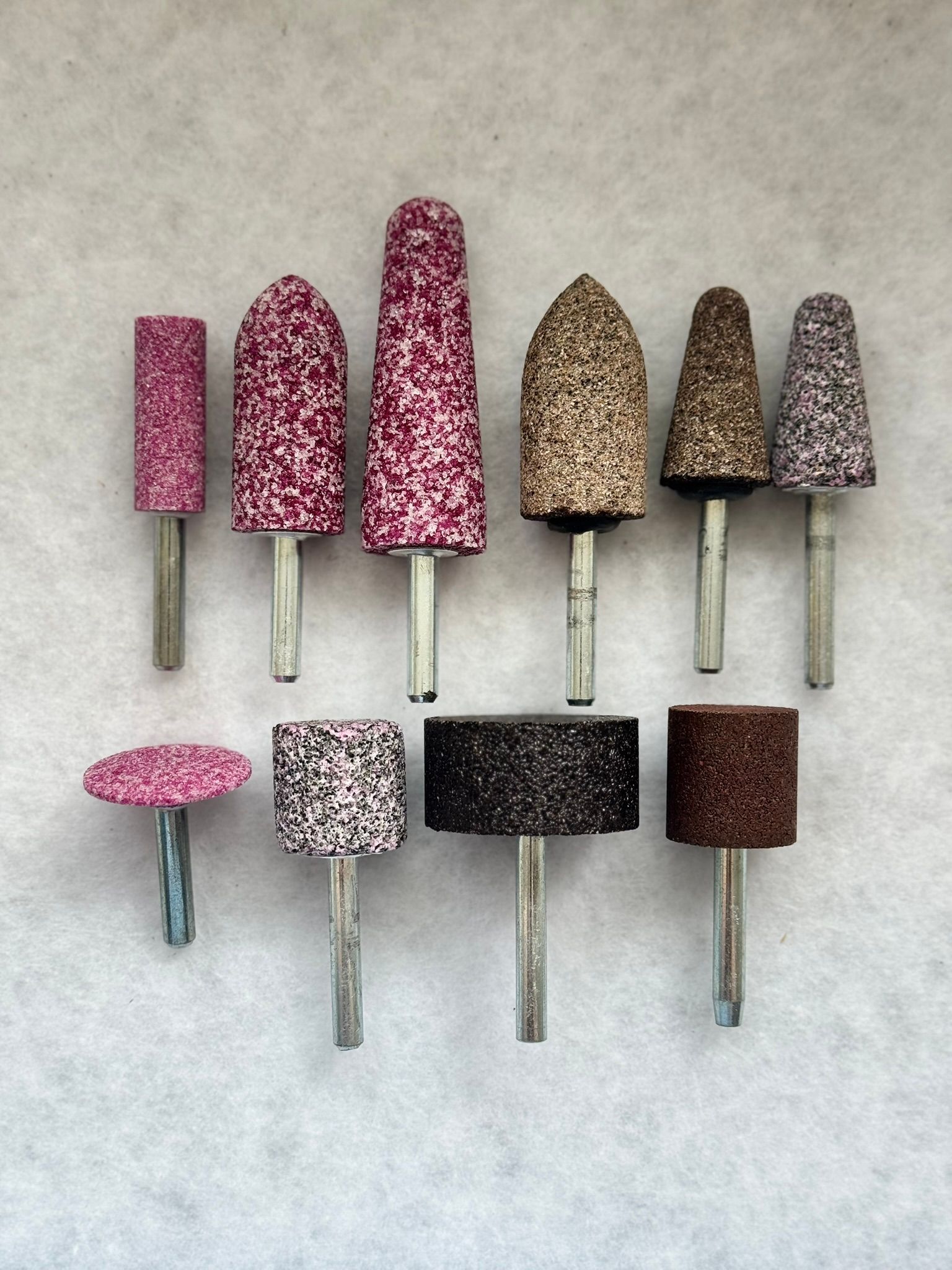 A bunch of different types of candles are sitting on a table.