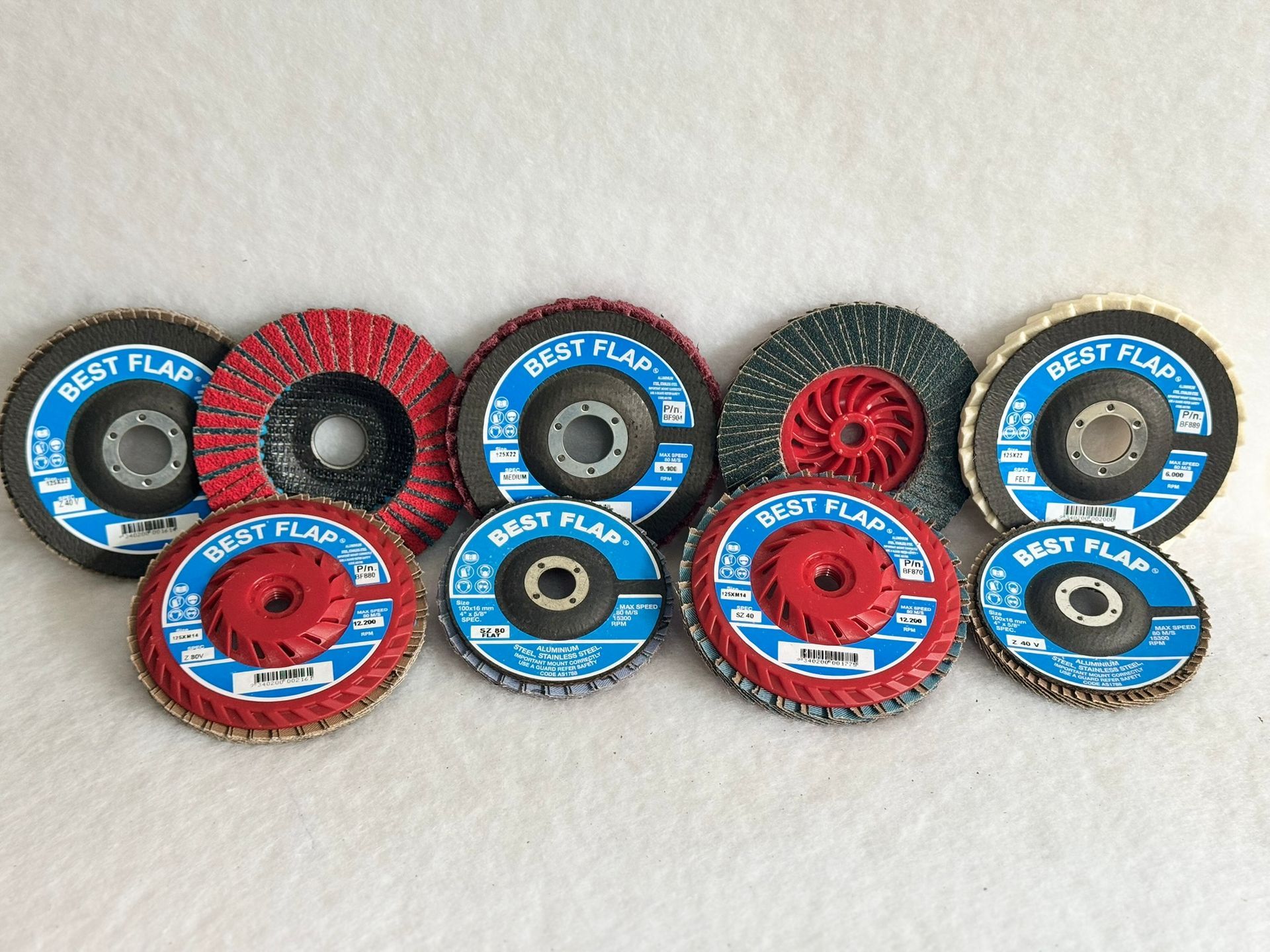 A group of polishing wheels are stacked on top of each other on a white background.
