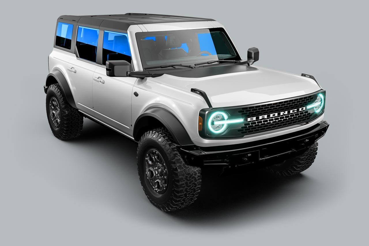 A white ford bronco is sitting on a gray surface.