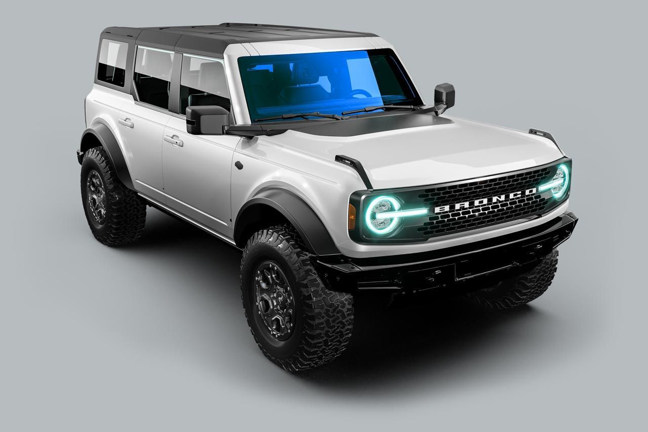 A white ford bronco is sitting on a gray surface.