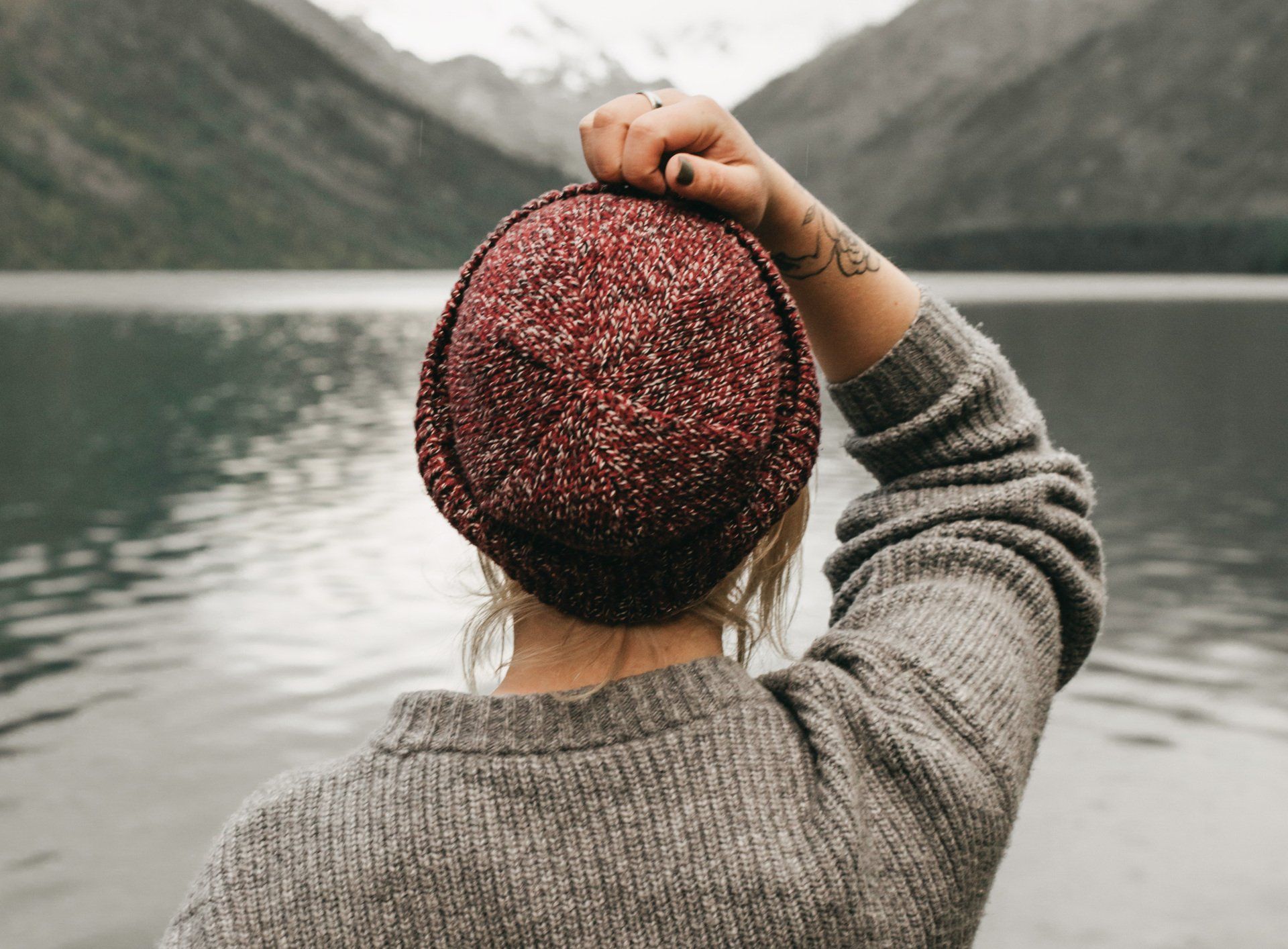 Girl wearing beanie staring out at the water