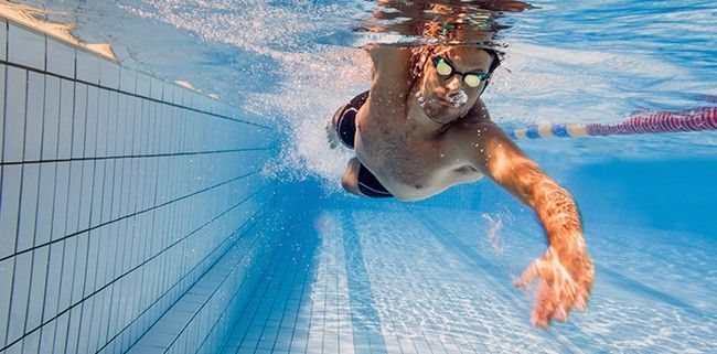 Man swimming laps in pool.