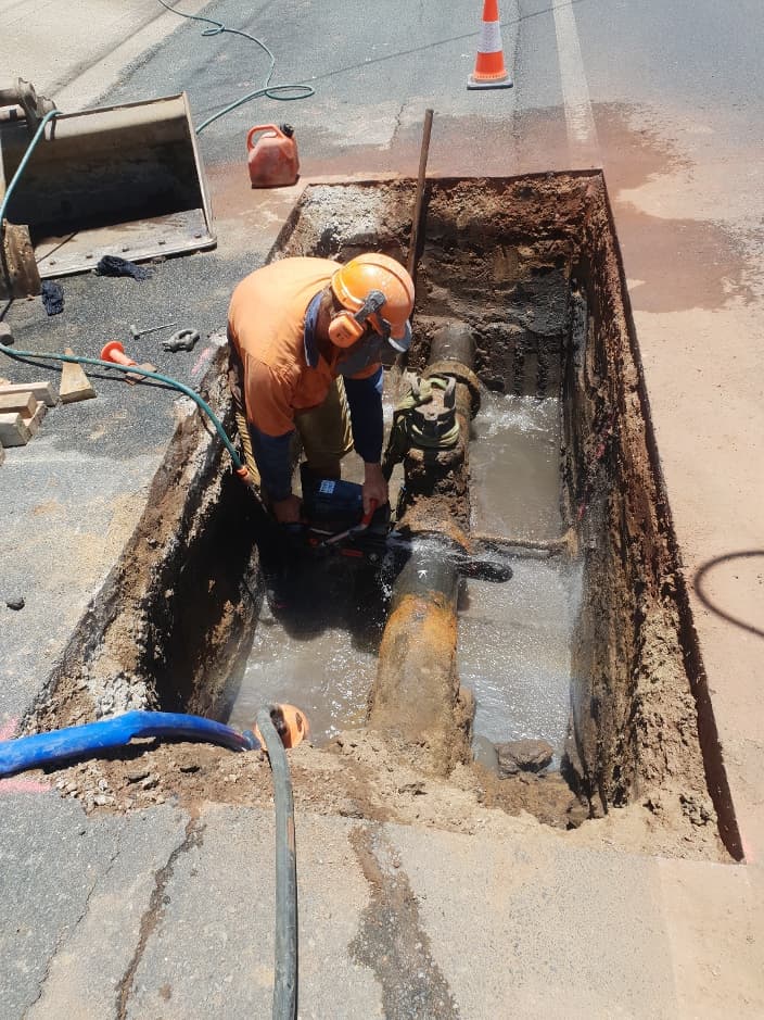 Worker Fixing Pipeline — Whitsunday Drainage Contractors in Airlie Beach, QLD