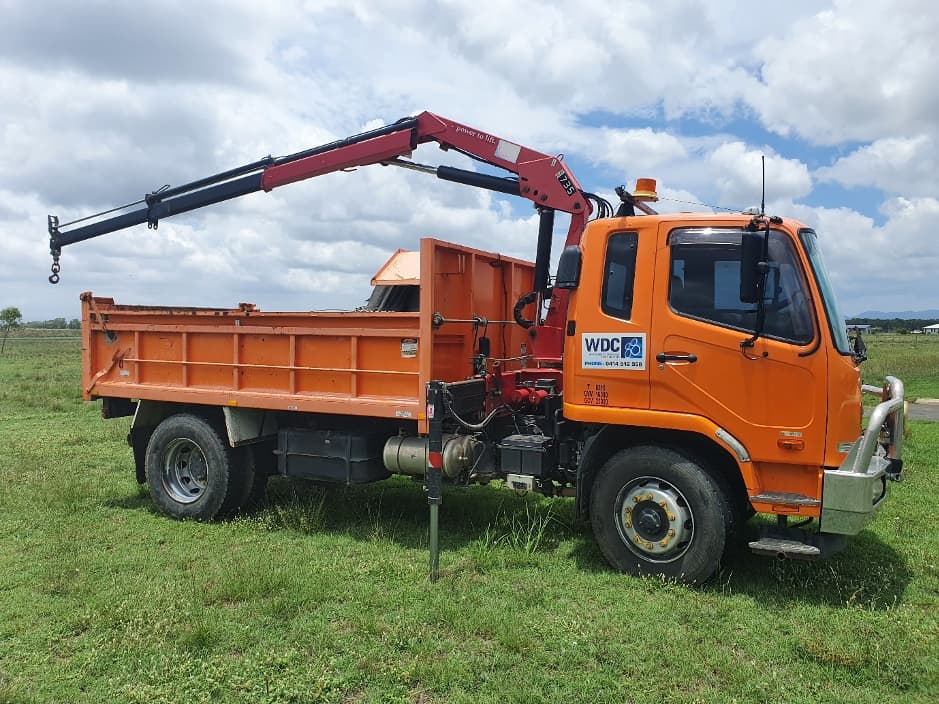 Orange Construction Truck — Whitsunday Drainage Contractors in Airlie Beach, QLD