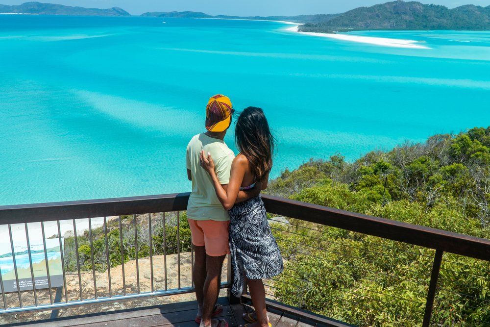 Couple on a BalconyOverlooking Whitehaven Beach — Whitsunday Drainage Contractors in Airlie Beach, QLD
