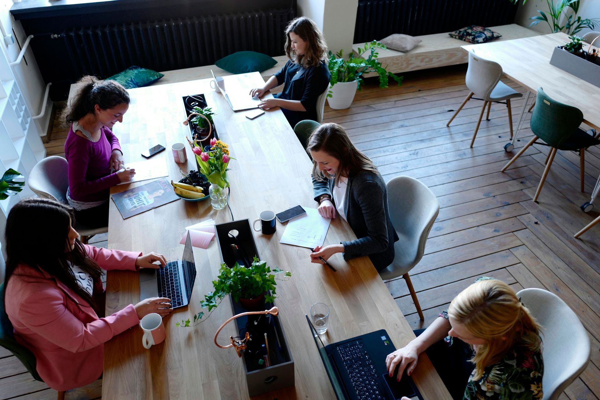 Business professionals planning comprehensive marketing strategy with documents and laptops
