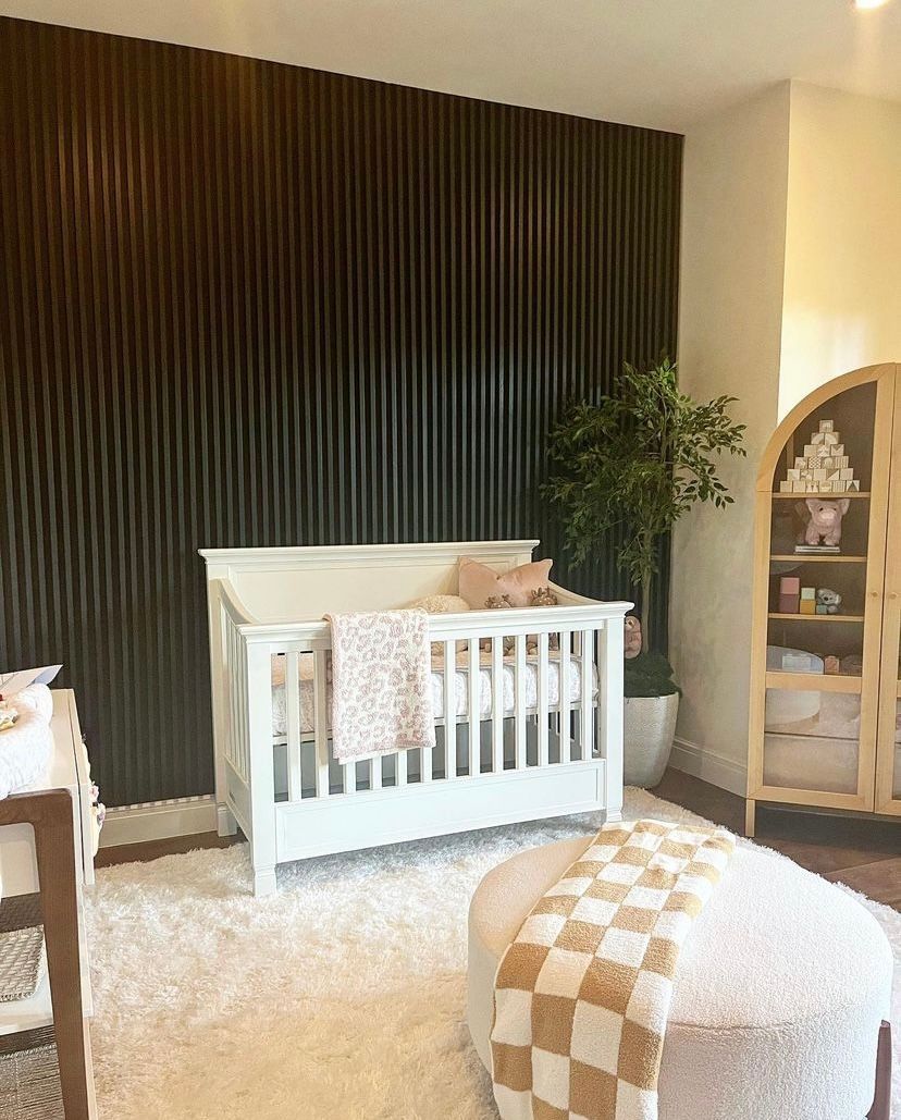 There is a crib in the middle of the room.