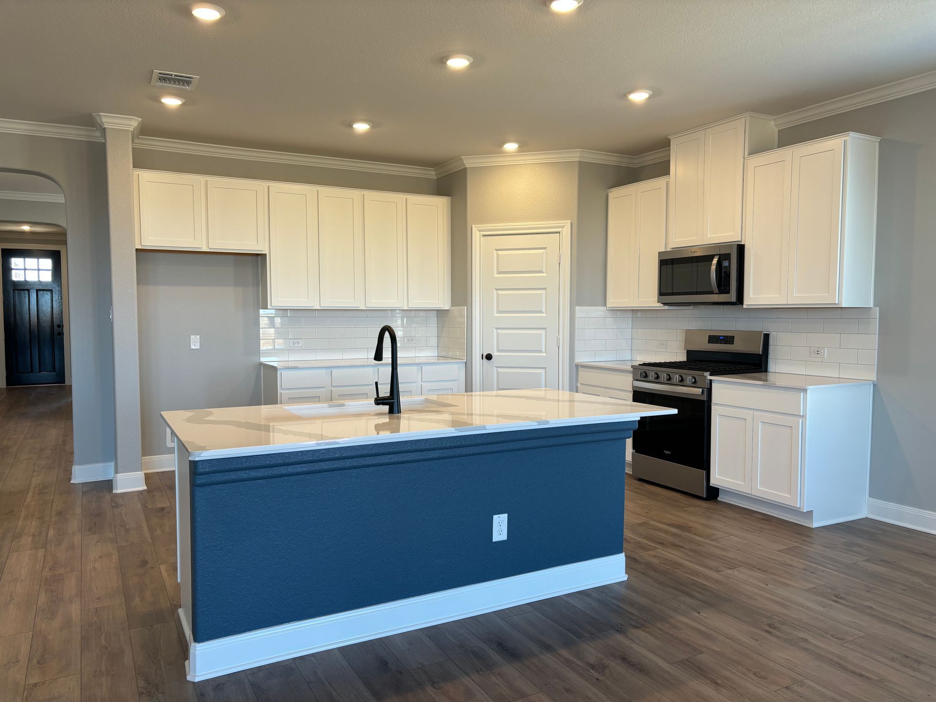 There is a large island in the middle of the kitchen.