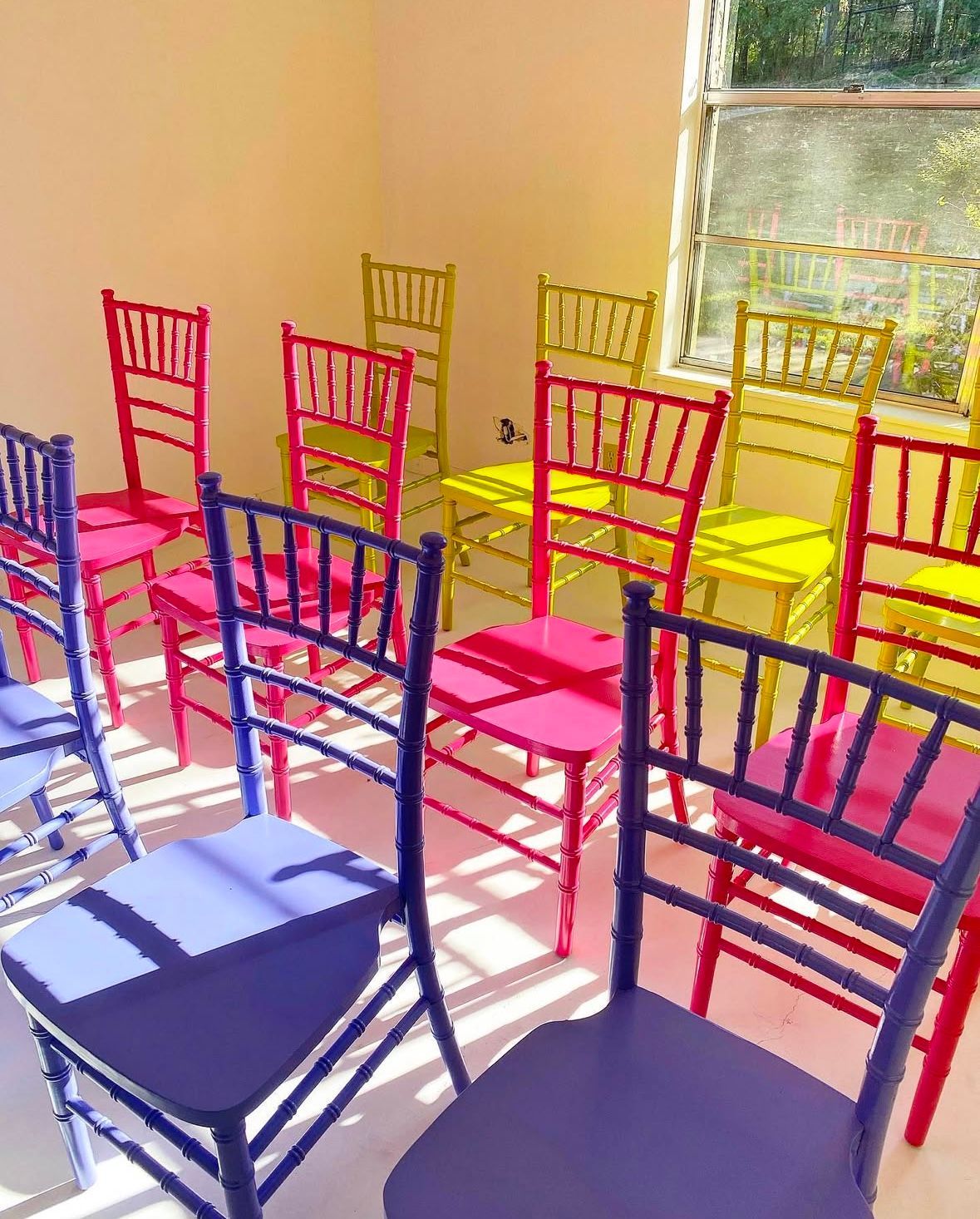 A row of colorful chairs are lined up in a room