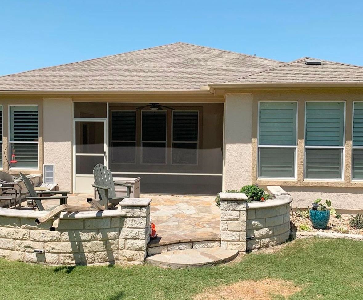 A house with a screened in porch and patio