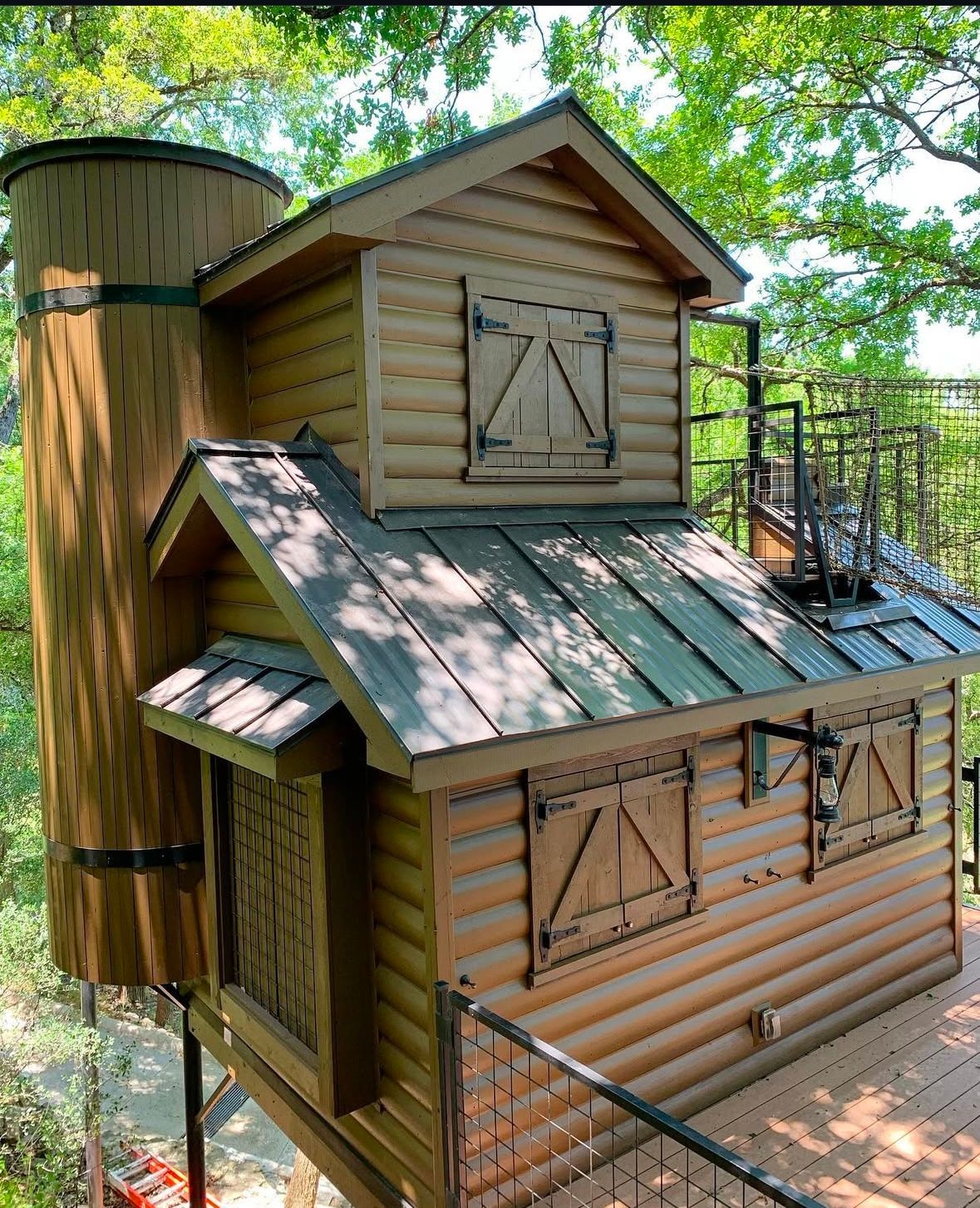 A small wooden house with a metal roof and stairs