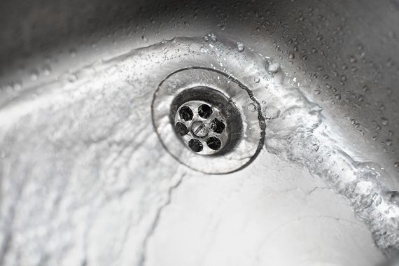 New Era Plumbing - A close up of a sink with water running down the drain.