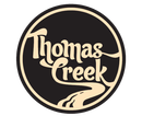 a logo for thomas creek with a river running through it
