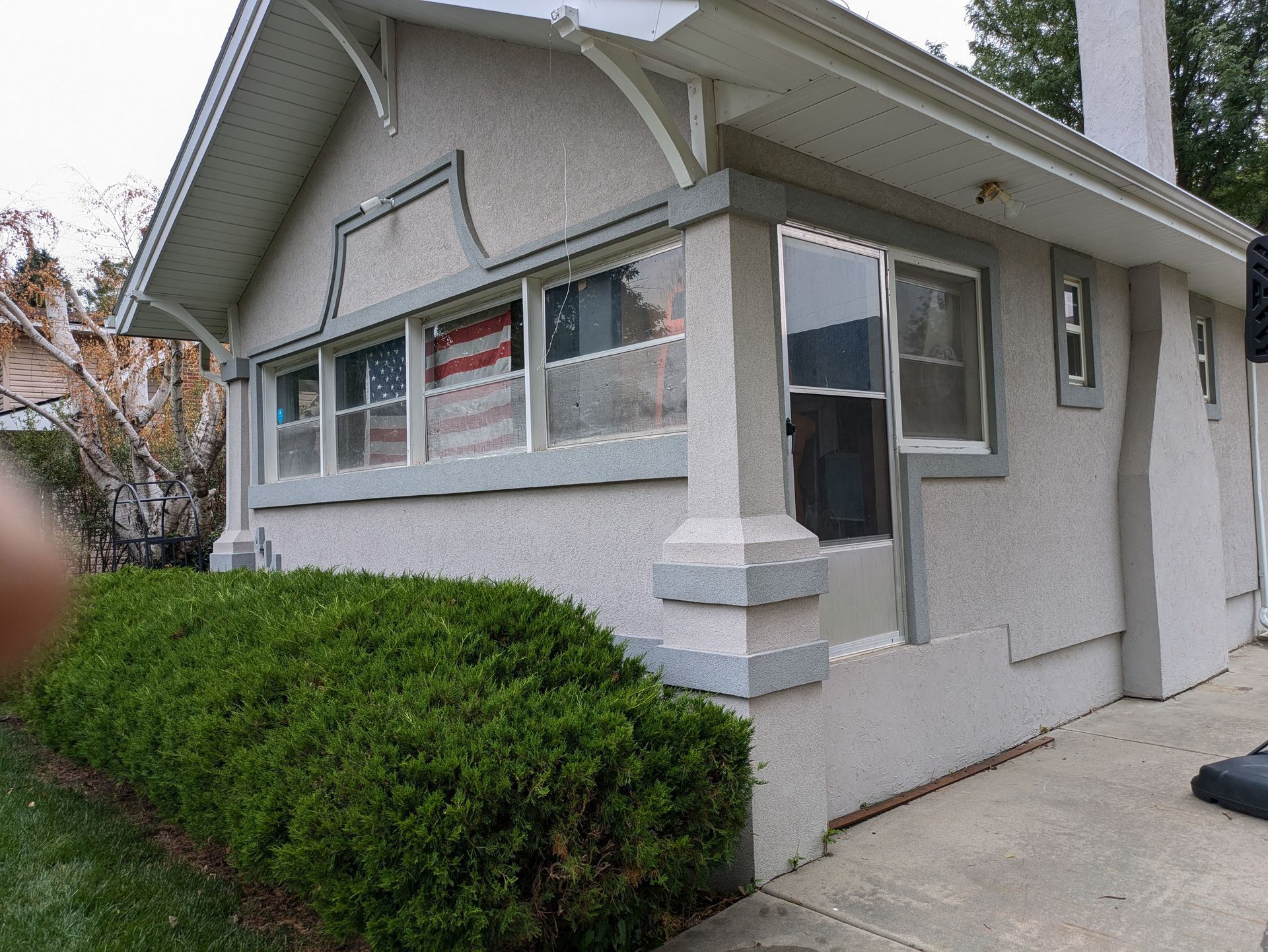 A small white house with a lot of windows
