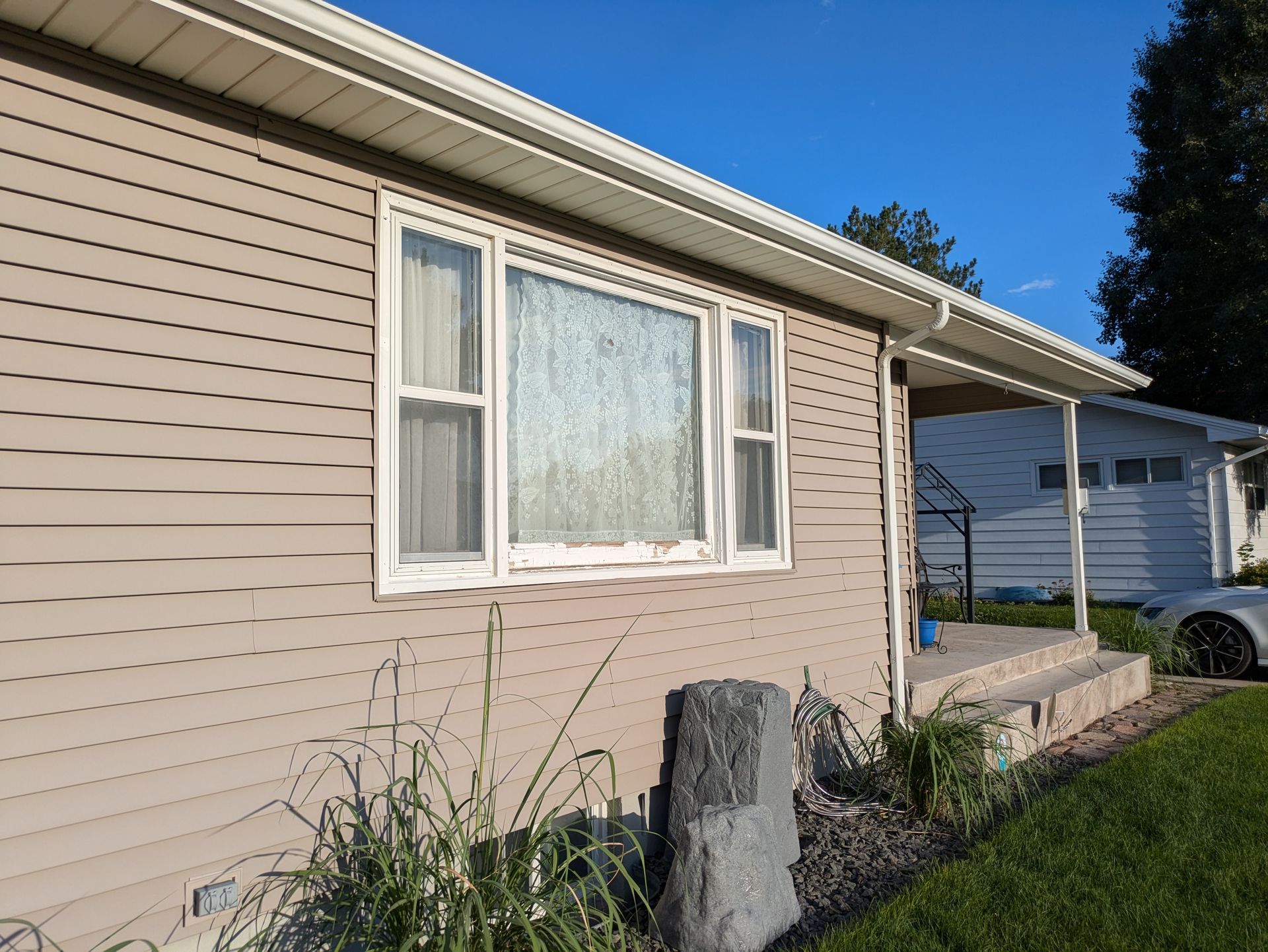 A house with a car parked in front of it