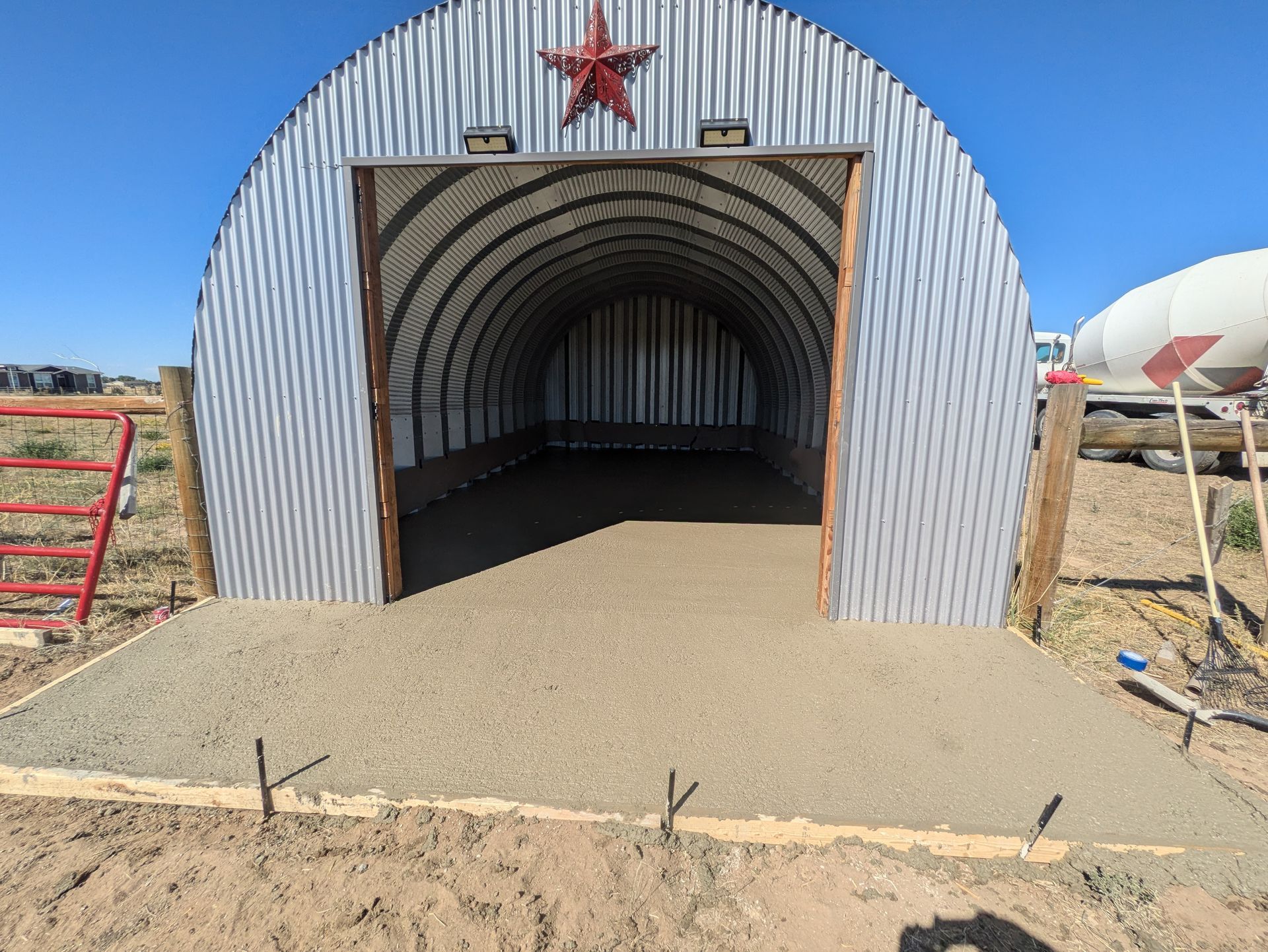 A large metal building with a star on the top of it.