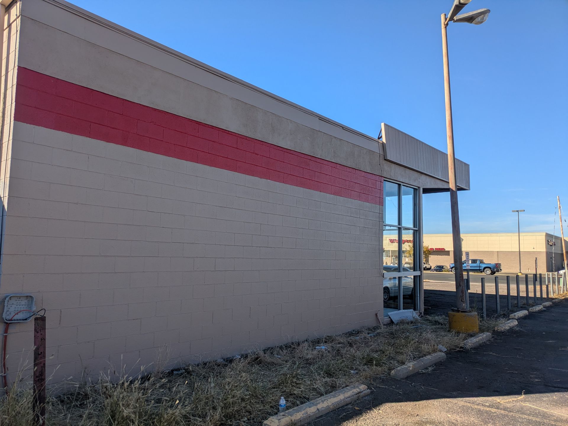 A building with a red stripe on the side of it