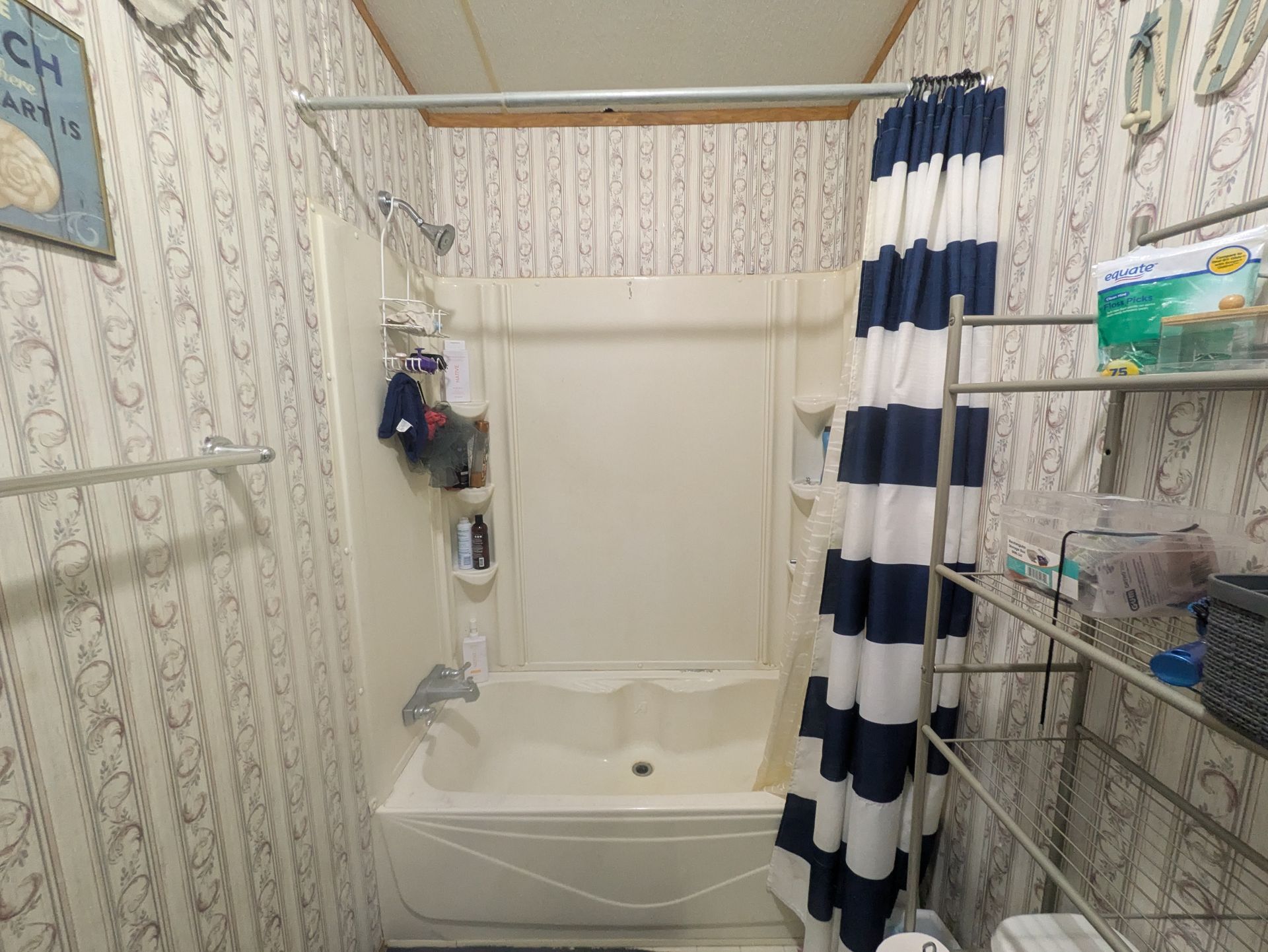 A bathroom with a bathtub and a shower curtain.
