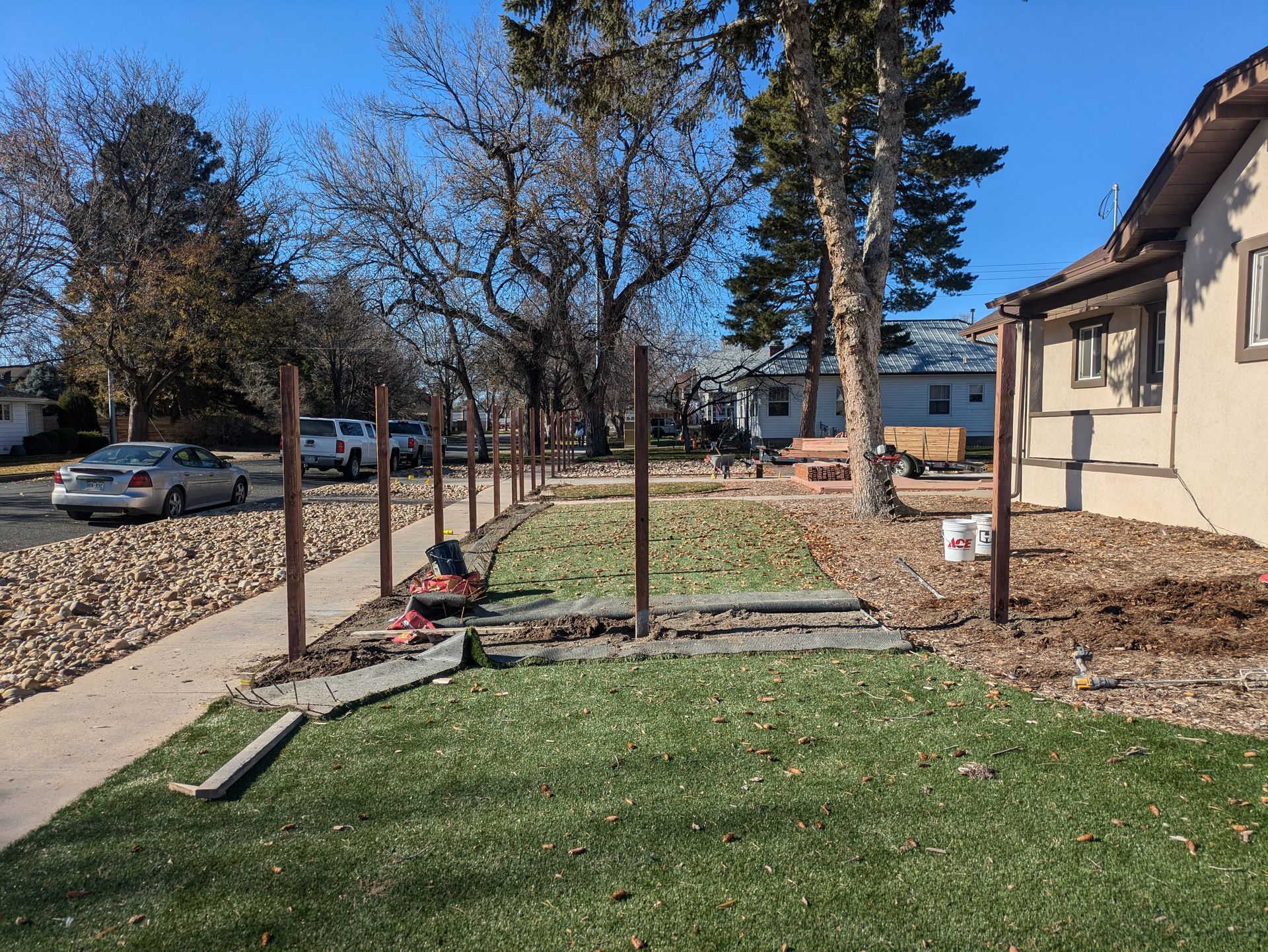 A fence is being built in front of a house.