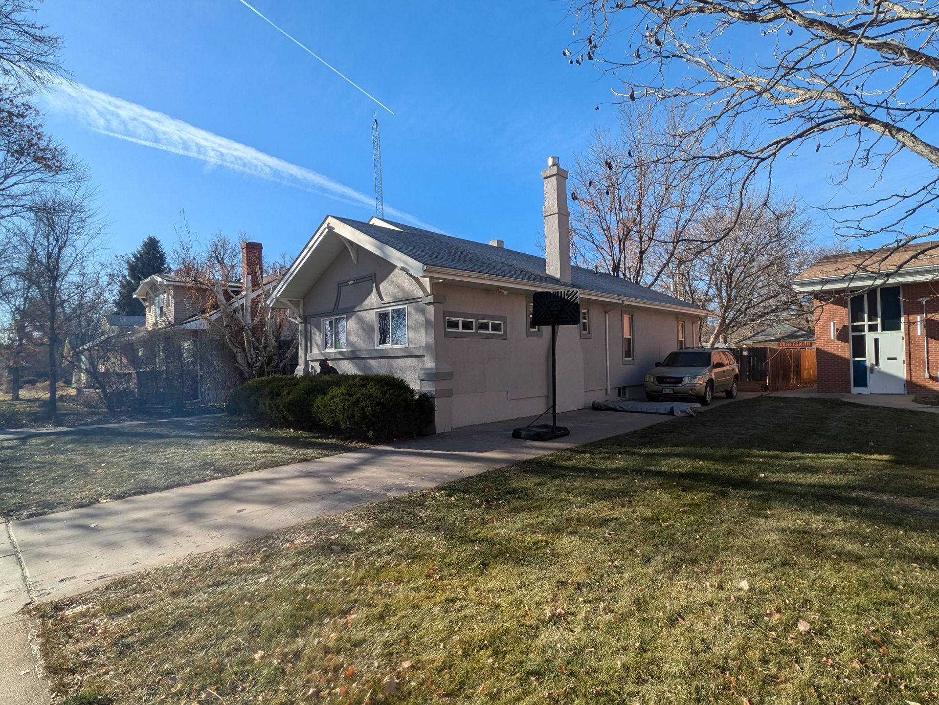 A house with a basketball hoop in front of it