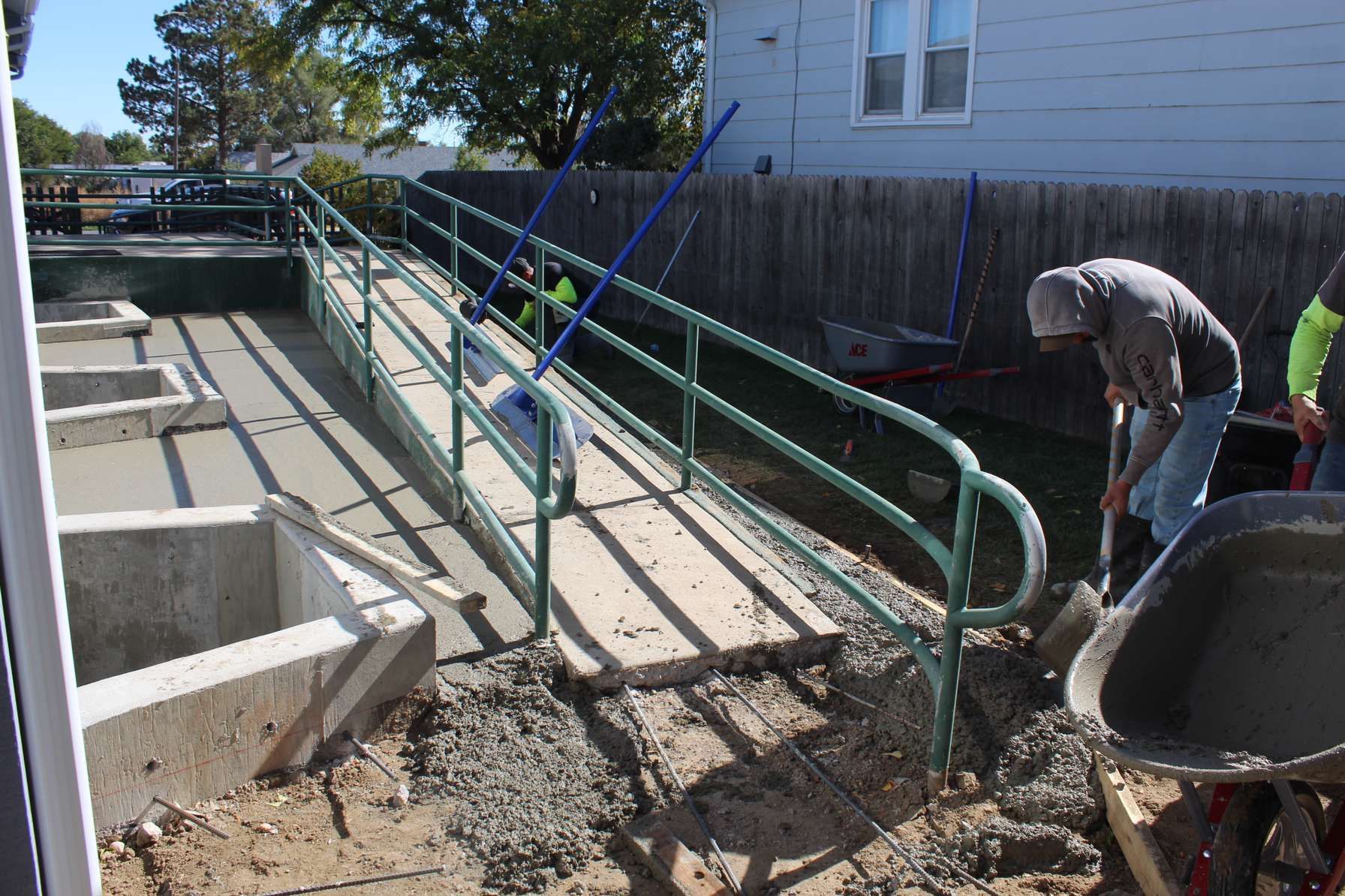 A man is digging in the dirt near a ramp