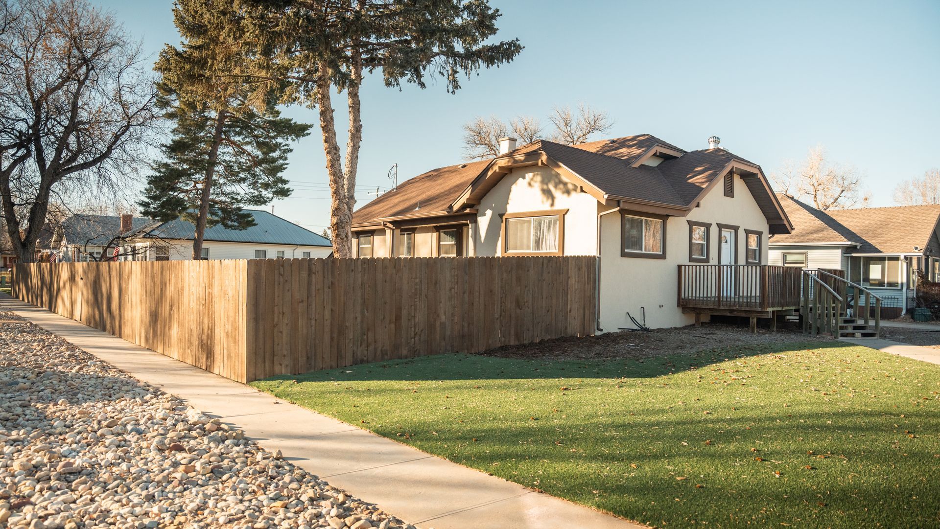 A house with a wooden fence in front of it
